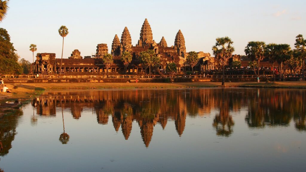 Angkor Wat reflected in water at golden hour