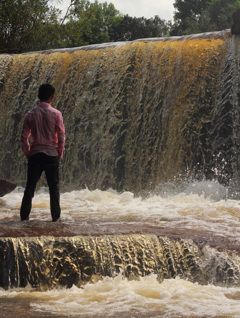 Kbal Chhay Waterfall surrounded by green vegetation
